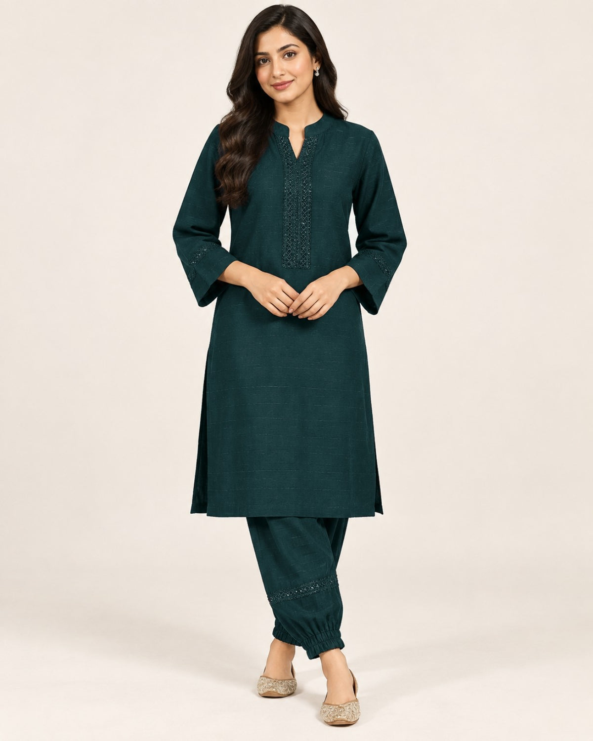 Deep teal kurta with embroidered neckline and three-quarter sleeves, paired with matching gathered-ankle trousers.