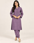 Mauve kurta with embroidered neckline and three-quarter sleeves, paired with matching gathered-ankle trousers.