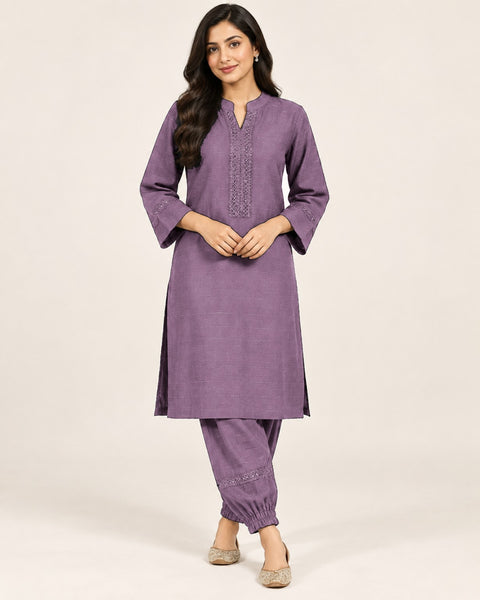 Mauve kurta with embroidered neckline and three-quarter sleeves, paired with matching gathered-ankle trousers.