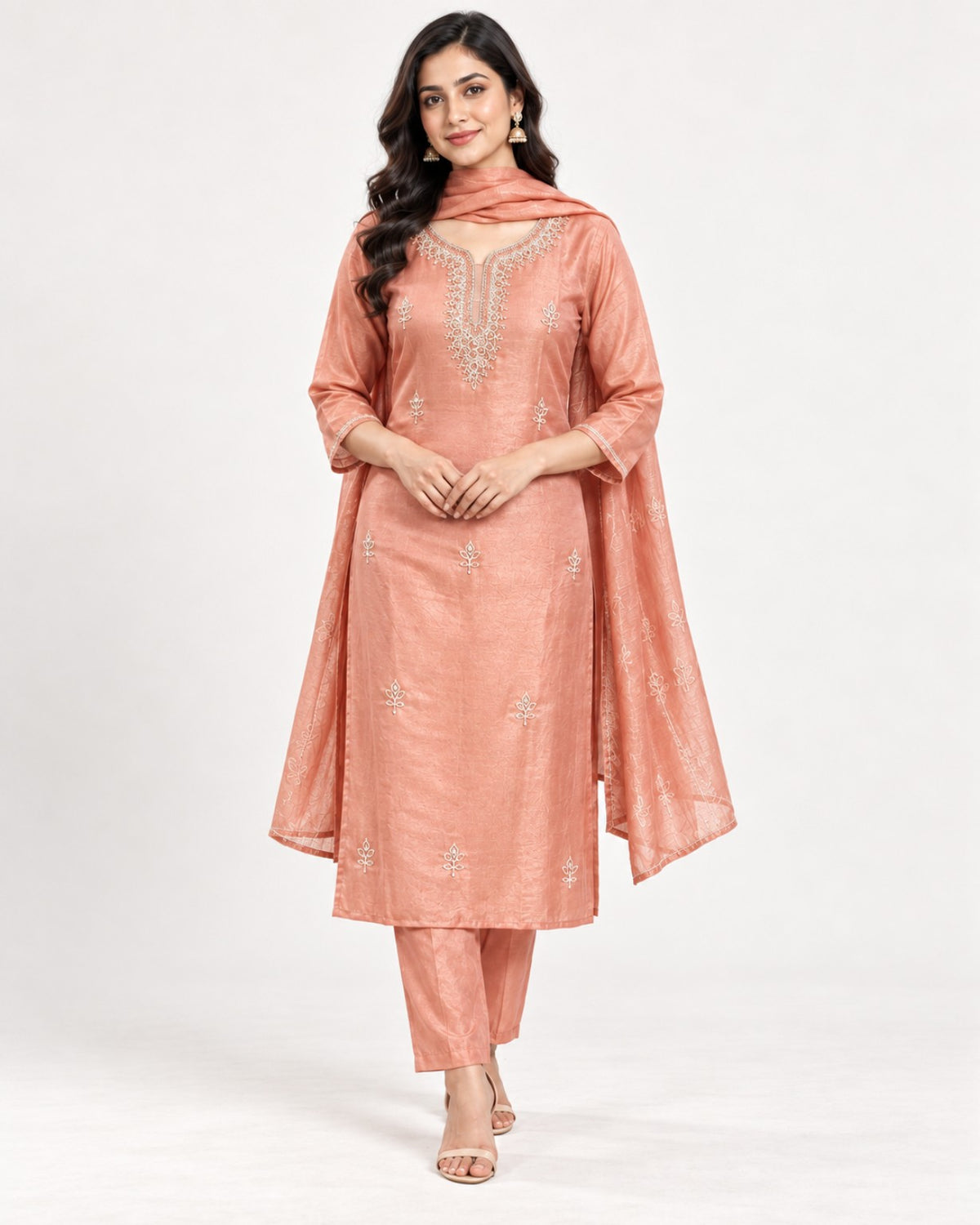 Peach kurta with an embroidered neckline and scattered floral motifs, paired with matching straight trousers and a dupatta.