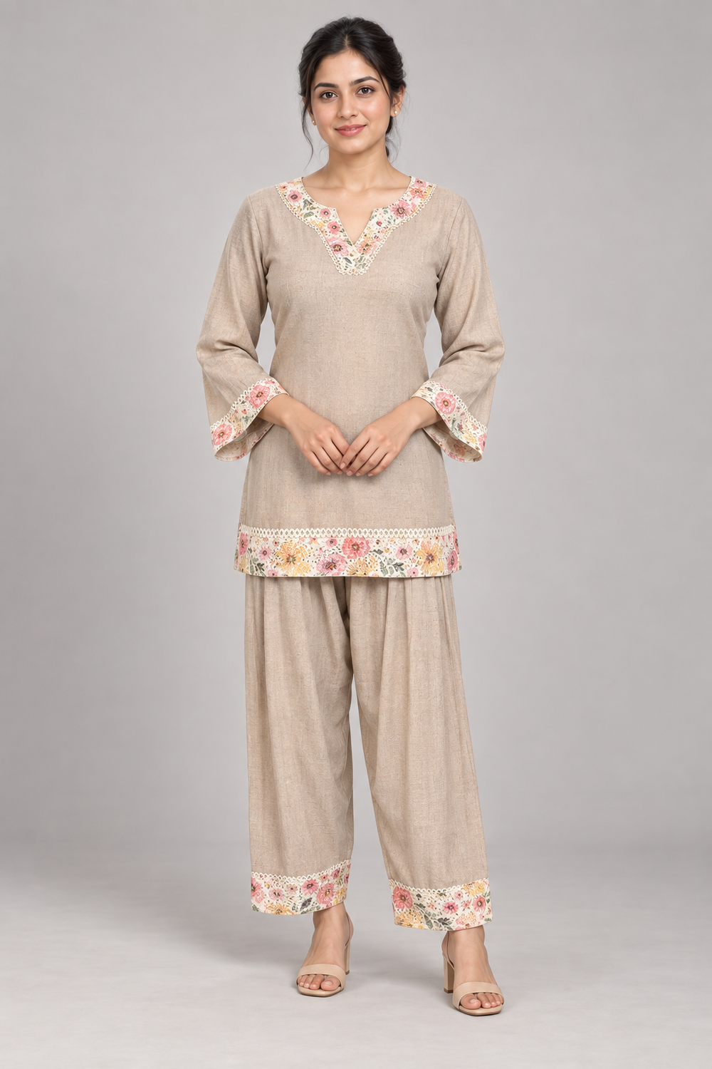 AI model wearing a taupe co-ord set with floral borders, bell sleeves and coordinating trousers.