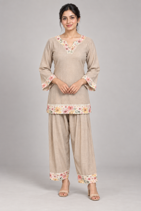 AI model wearing a taupe co-ord set with floral neckline, bell-sleeve cuffs and matching trouser borders.